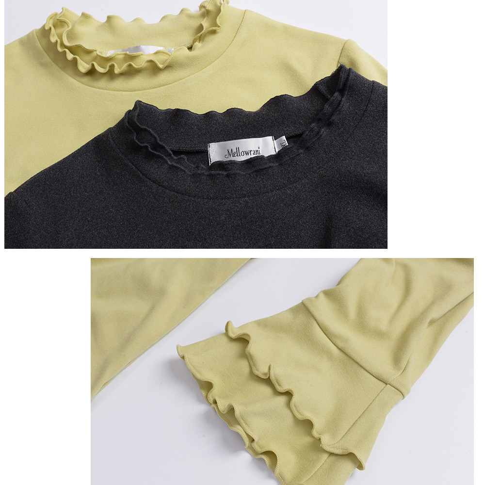 二重フリルのスタンドカラーとベルカフのフィット感のあるトップス9